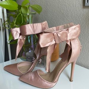 Pink suede heels with a bow